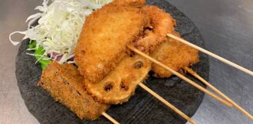 Kushikatsu auf einem Teller mit Krautbeilage