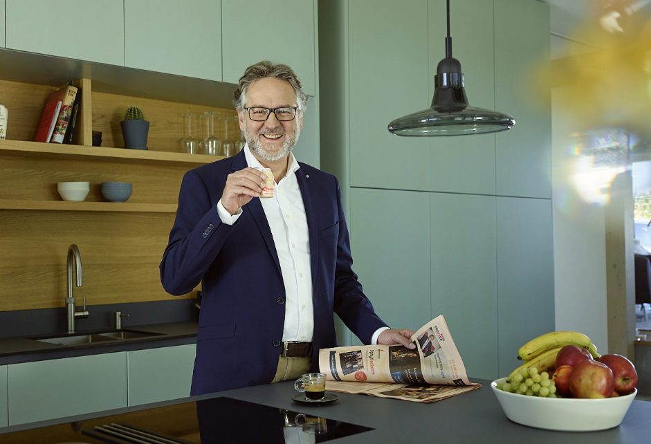 Eberhard trinkt in der Küche ein Fläschchen Yakult