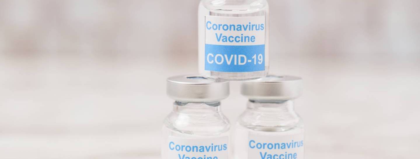 Drei Glasfläschchen mit Corona-Impfstoff