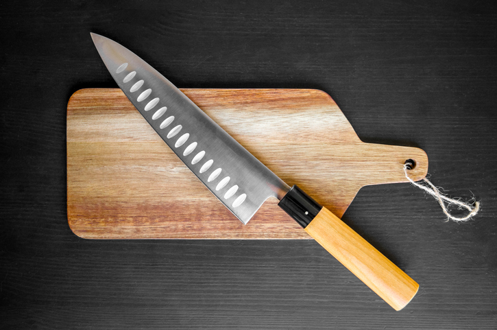 Traditional Japanese gyuto knife on a cutting board