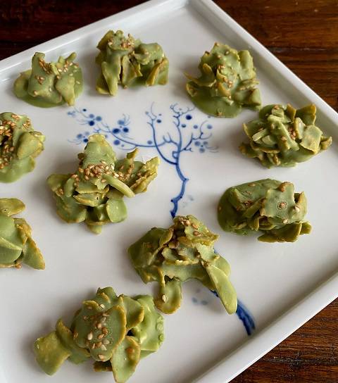 Matcha-Crossies mit Sesam auf weißem Porzellanteller mit blauer Malerei