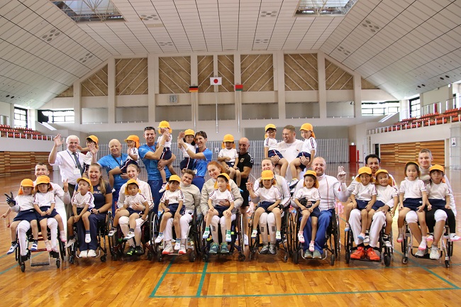 Das deutsche und belarussische Rollstuhlfecht-Team mit den Kindern von Tagawa.