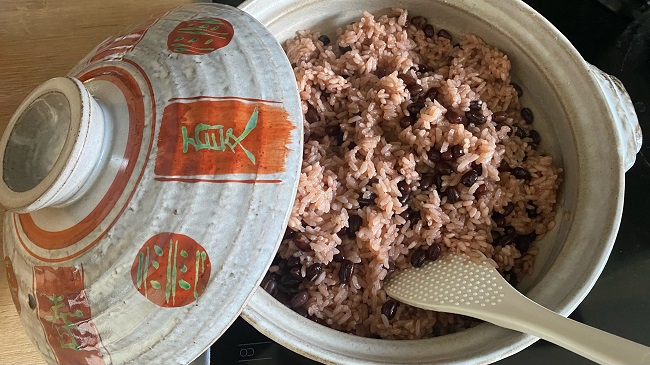 Roter Reis mit Azukibohnen serviert in Reisschüssel mit Deckel