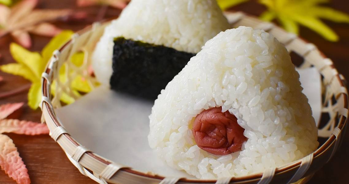 Mit Umeboshi (eingelegter Pflaume) gefüllte, dreieckige Onigiri