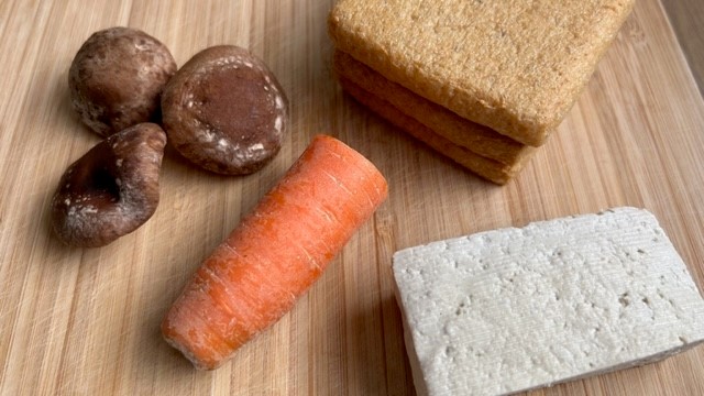 Tofu, Shiitake-Pilze, Abura-Age (frittierte Tofu-Scheiben) und eine Karotte