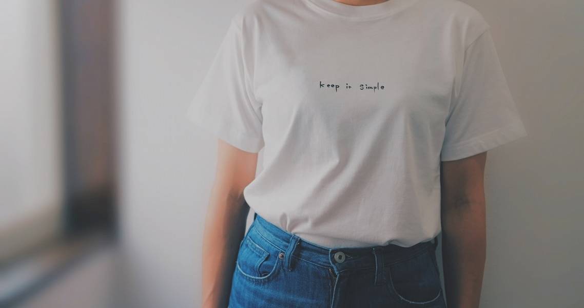 Frau im weißen T-Shirt mit der Aufschrift "Keep it simple"