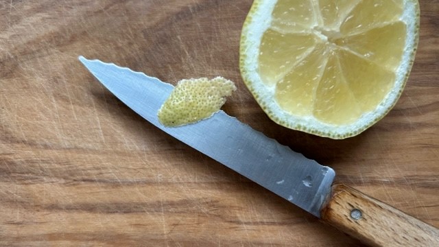 Zitrone auf Schneidebrett mit Messer